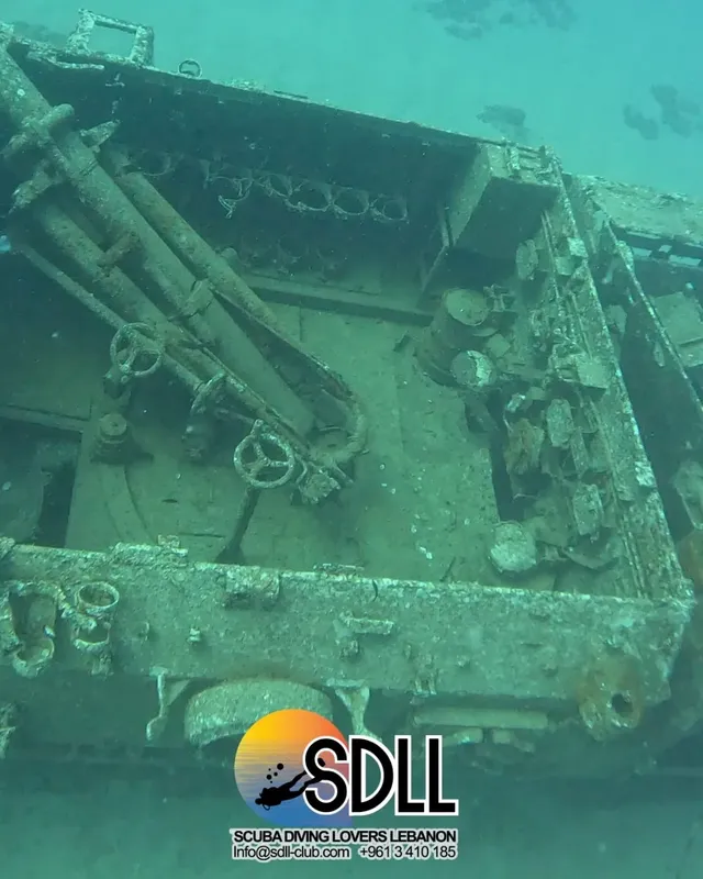 Épave de bateau rouillée sous l'eau avec logo SDLL en bas