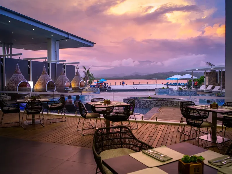 Terrasse d'un restaurant avec vue sur la mer et le ciel coloré