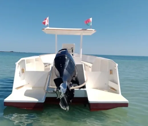 Bateau blanc et rouge amarré sur une mer turquoise calme