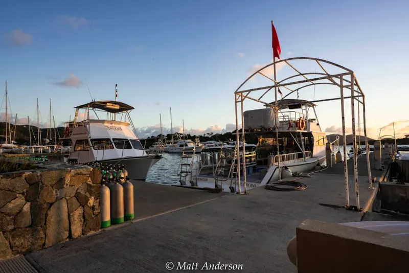 Bateaux de plongée amarrés au port avec des bouteilles à quai