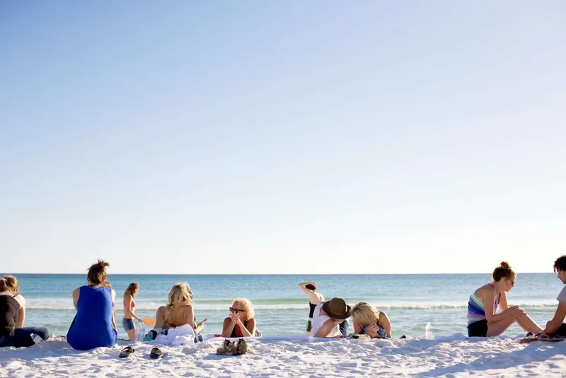 Groupe de personnes se relaxant sur une plage ensoleillée au bord de la mer