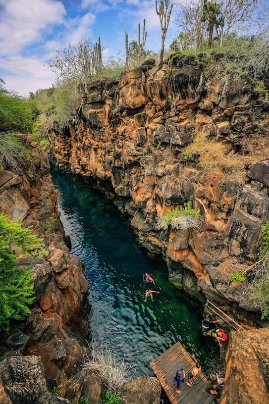 Personnes se baignent et se détendent dans un canyon rocheux turquoise