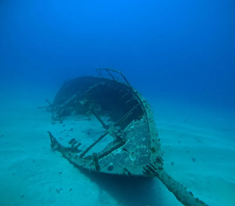 Epave de bateau coulee sur fond sableux en milieu aquatique