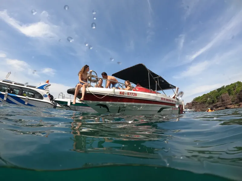 Personnes à bord d'un bateau de plongée sur une mer calme
