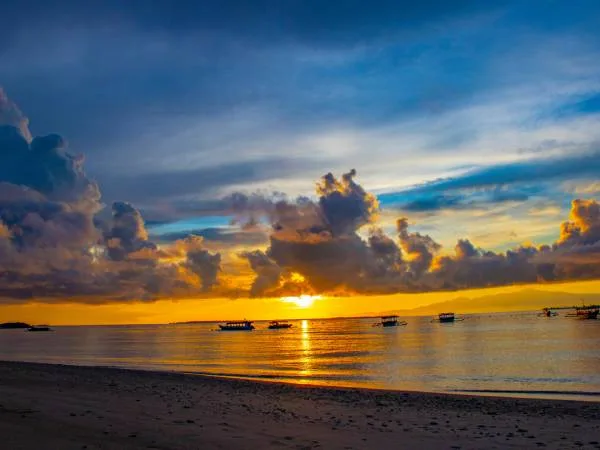 Coucher de soleil sur la mer avec des bateaux à l'horizon
