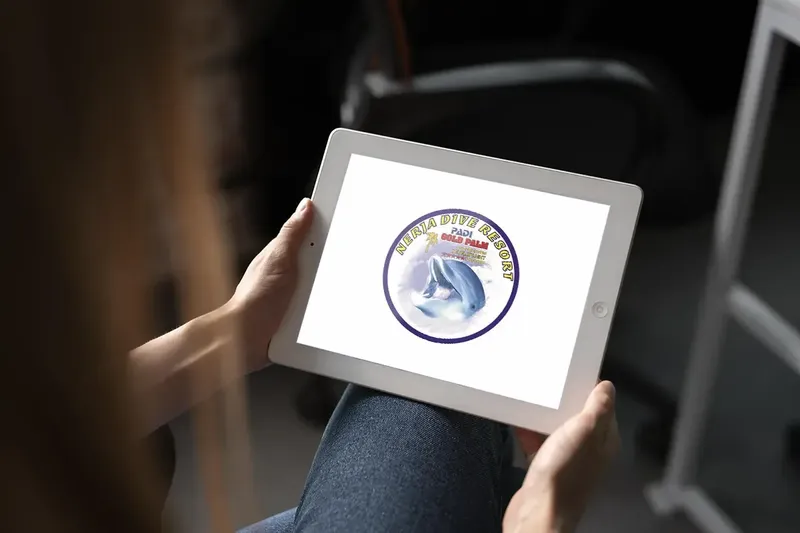 Personne tenant une tablette affichant le logo d'un centre de plongée