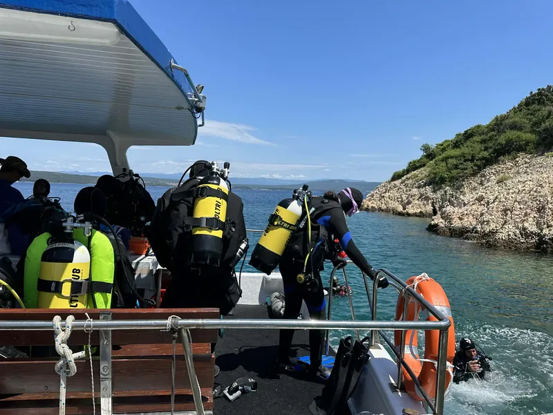 Plongeurs préparant leur matériel à bord d'un bateau de plongée en mer