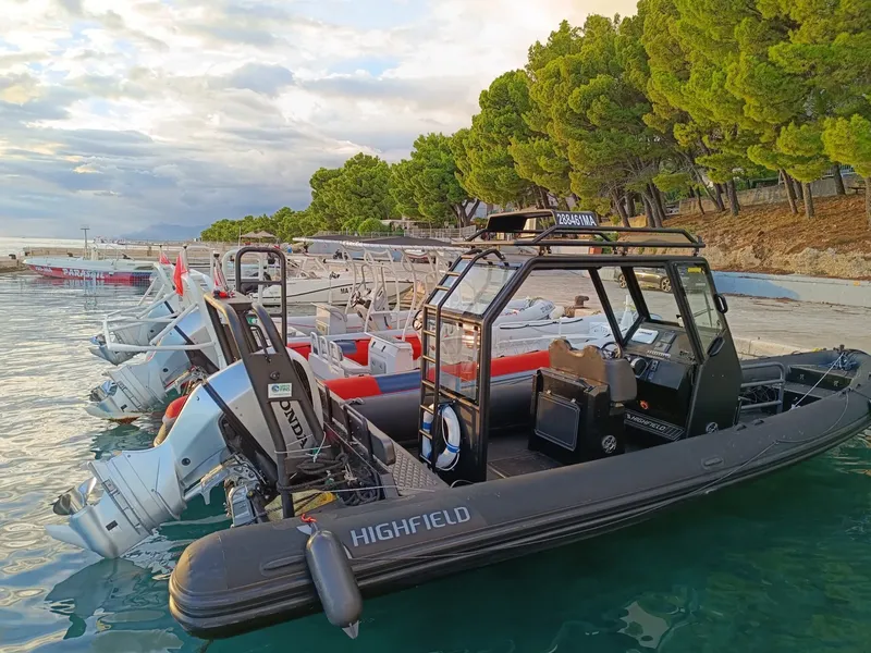 Plusieurs bateaux pneumatiques amarrés dans une eau turquoise ensoleillée