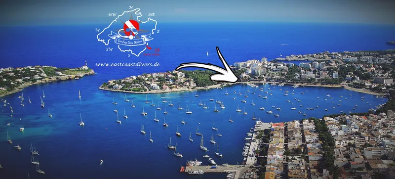 Vue aérienne d'une côte avec des bateaux et une flèche blanche