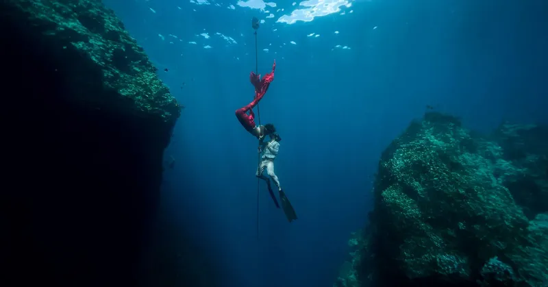 Apnée en profondeur, une plongeuse descend le long d'un câble