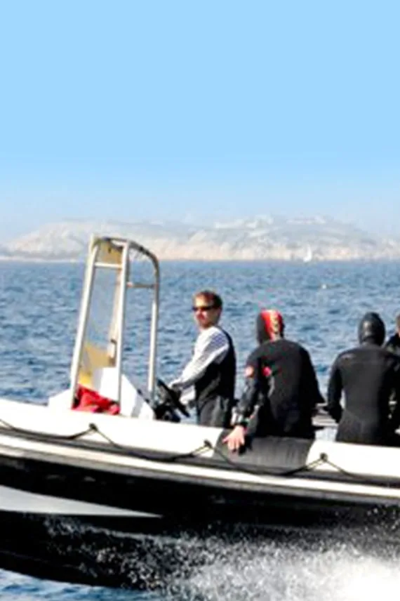 Plongée : un bateau semi-rigide transporte des plongeurs en combinaison