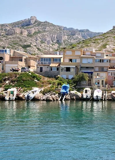 Port de village avec bateaux amarrés au bord de l'eau et montagne