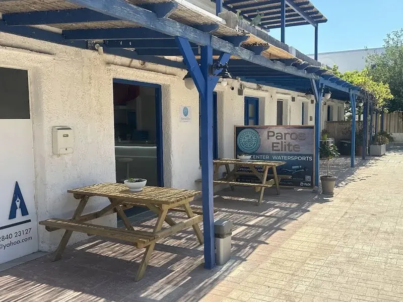 Façade d'un centre de sports nautiques avec tables et enseigne