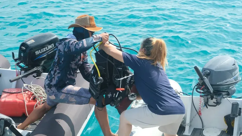 Préparation d'un plongeur sur un bateau pneumatique en mer turquoise