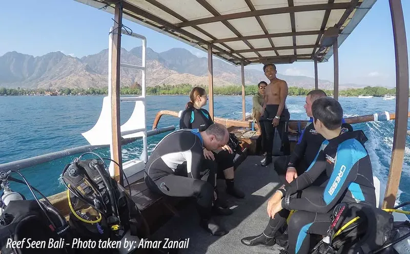 Plongeurs préparant leur matériel à bord d'un bateau en mer