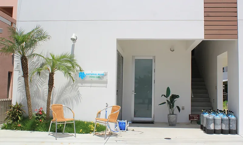 Façade d'un centre de plongée avec bouteilles et mobilier extérieur