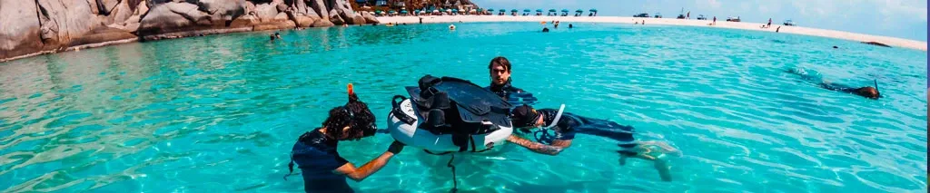 Plongée en eau peu profonde avec équipement sur le dos des plongeurs
