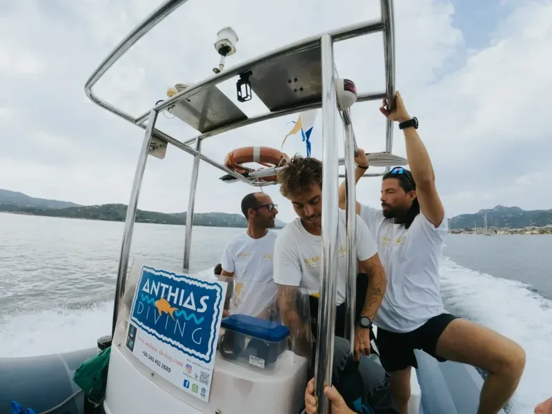 Trois plongeurs à bord d'un semi-rigide en direction d'un site