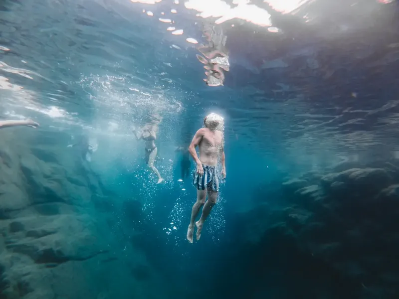 Plongée sous-marine avec des nageurs explorant un environnement aquatique bleu