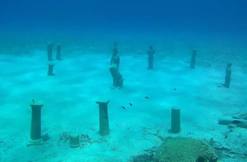 Ruines antiques submergées avec des colonnes et du sable clair