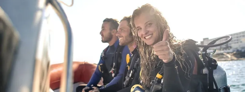 Plongeurs souriants sur un bateau, équipement complet, signe de validation