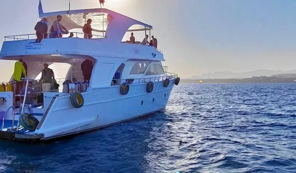 Bateau de plongée blanc avec des personnes à bord en mer