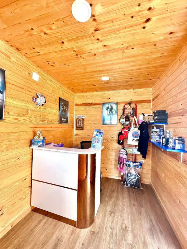 Intérieur d'un centre de plongée avec comptoir, matériel et décoration bois