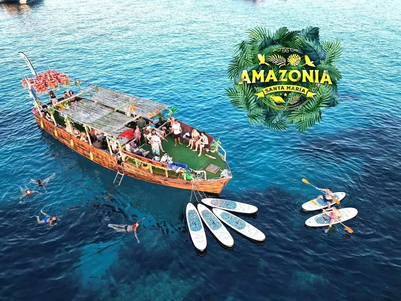 Bateau de plaisance avec des personnes, des nageurs et des planches