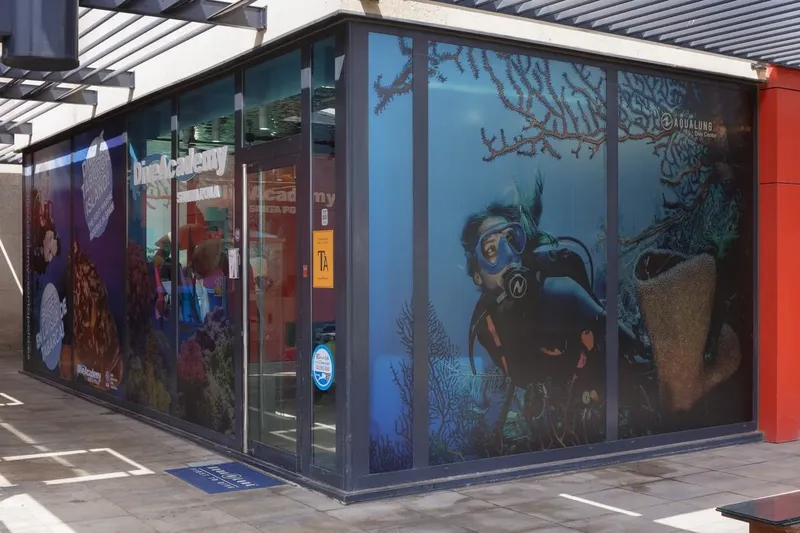 Façade d'un centre de plongée avec des visuels de plongeurs en action