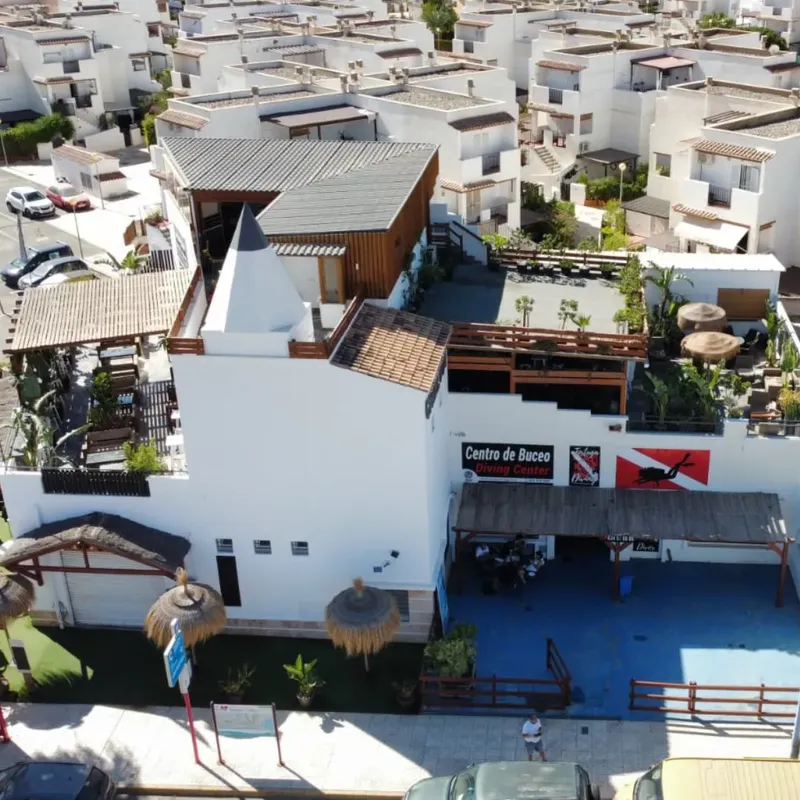 Vue aérienne d'un centre de plongée avec des bâtiments blancs et des palmiers