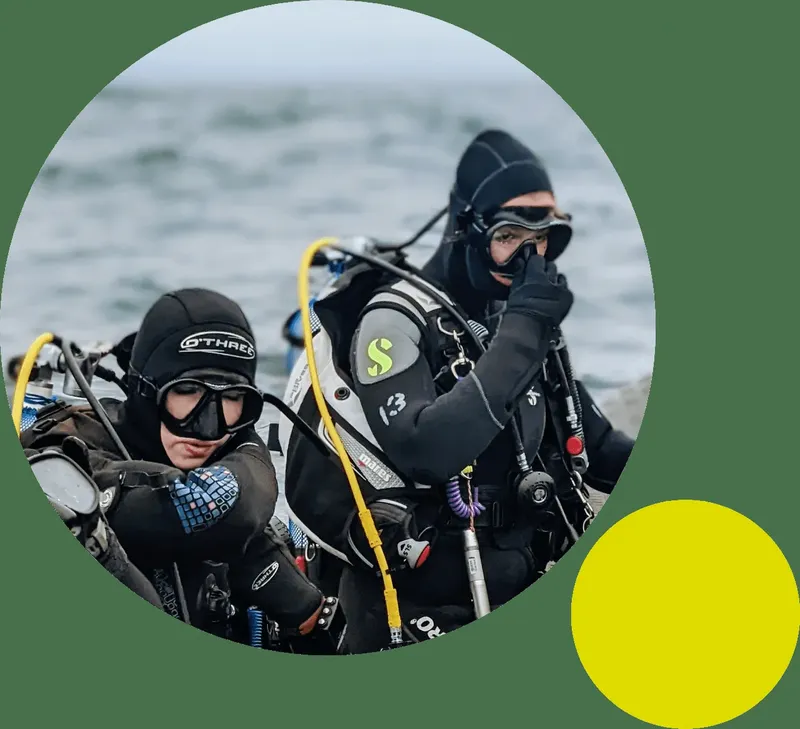 Deux plongeurs équipés se préparent pour une immersion en mer