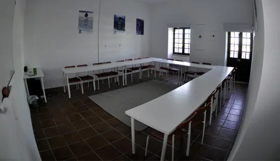 Salle de cours de plongée avec tables, chaises et affiches murales