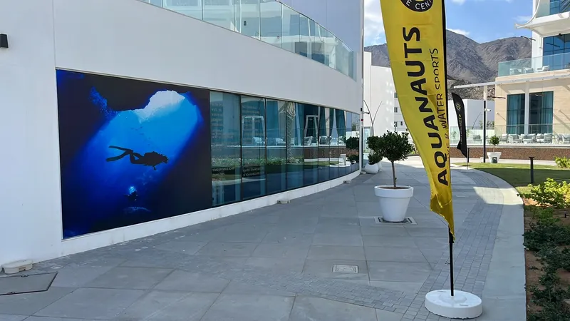 Façade d'un centre de plongée avec une grande image sous-marine et un drapeau