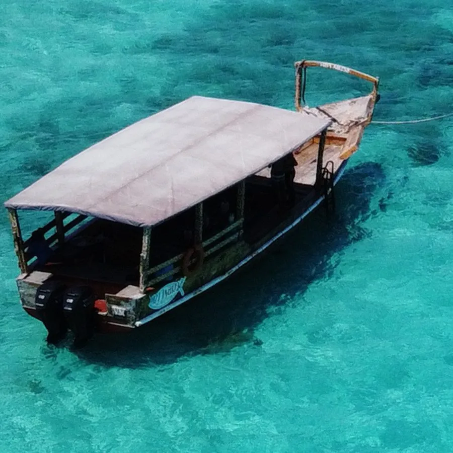 Bateau de pêche traditionnel sur une eau turquoise et claire
