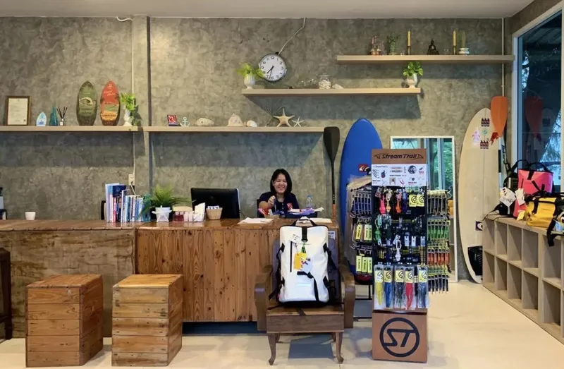 Comptoir d'accueil d'un centre de plongée avec une employée souriante