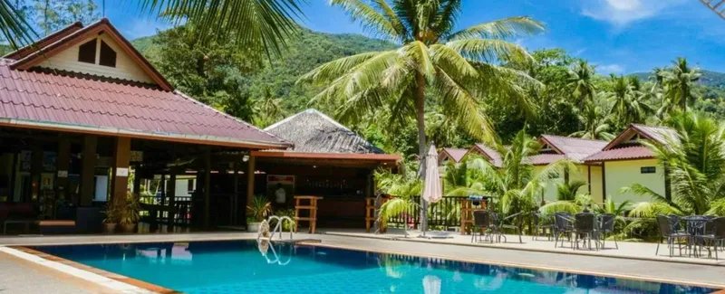 Bâtiments d'un centre de plongée avec piscine et végétation tropicale