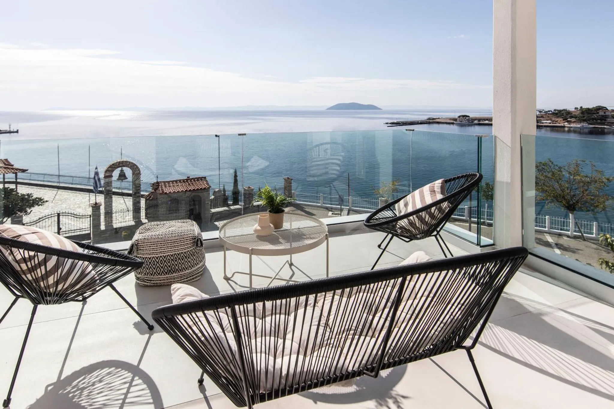 Terrasse avec mobilier d'extérieur et vue sur la mer.
