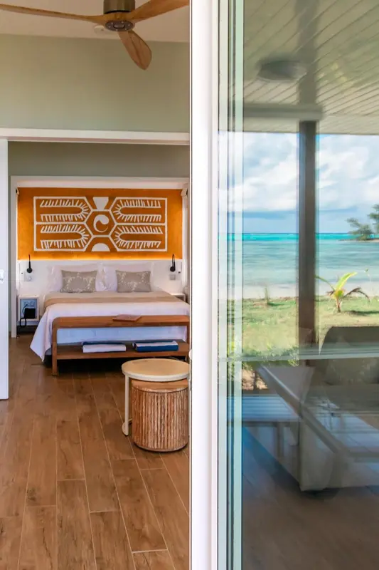 Une chambre lumineuse avec un lit double et une vue sur la mer.