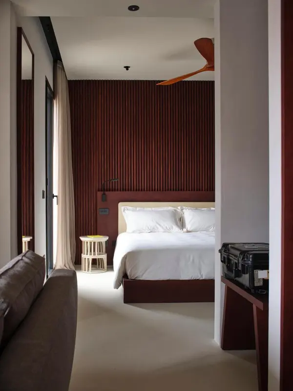 Une chambre lumineuse avec un grand lit et un canapé.