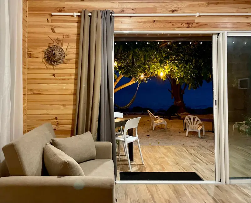 Un espace de détente intérieur s'ouvre sur une terrasse éclairée.