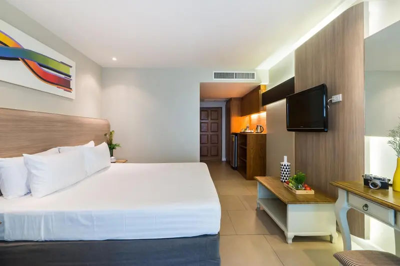 Une chambre lumineuse avec un grand lit et un espace détente.