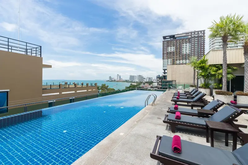 Une piscine à débordement offre une vue sur la mer et la ville.