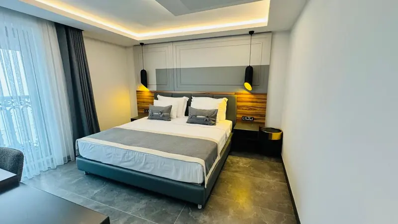 Une chambre moderne avec un grand lit et une décoration sobre.