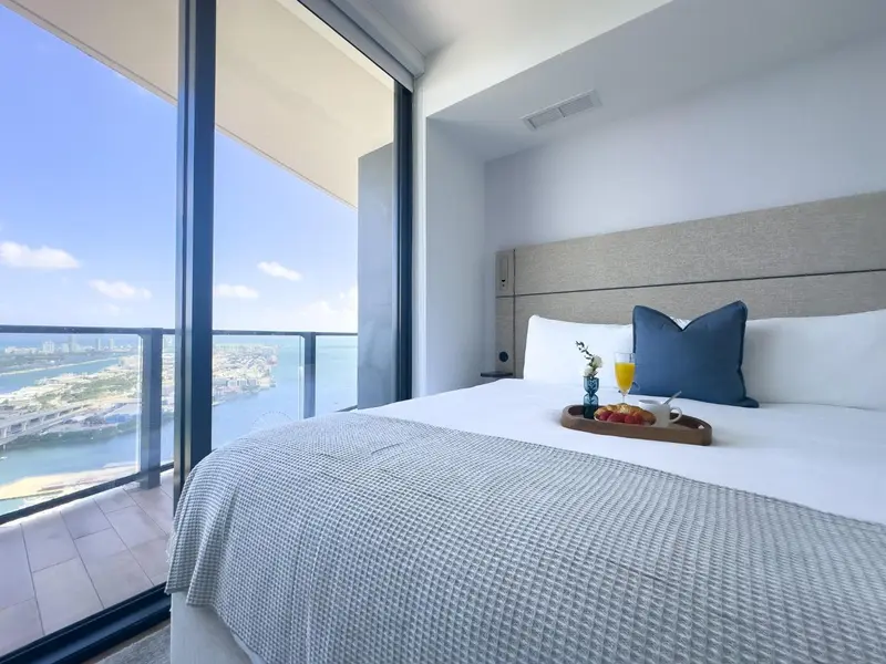 Une chambre lumineuse avec un grand lit et une vue sur la mer.