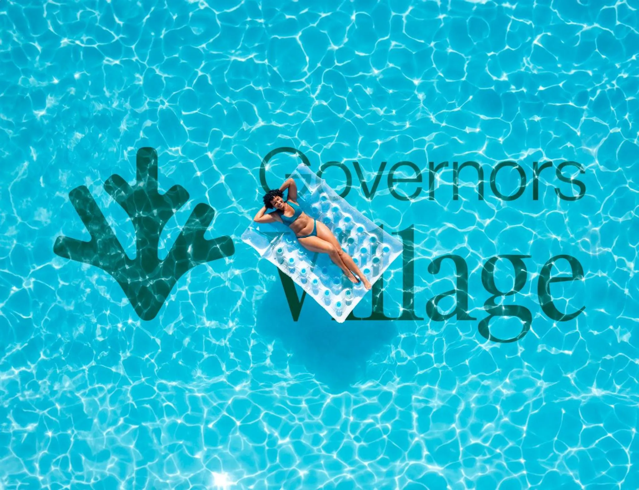 Une personne se détend sur un matelas flottant dans une piscine turquoise.