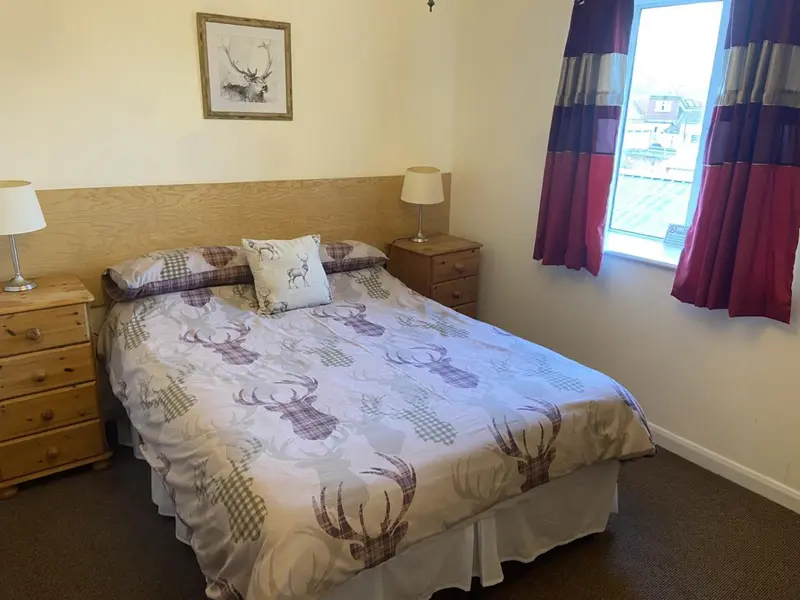Une chambre à coucher avec un lit double et une décoration sobre.