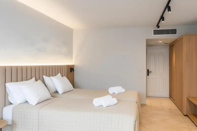 Une chambre lumineuse avec un grand lit et une décoration sobre.