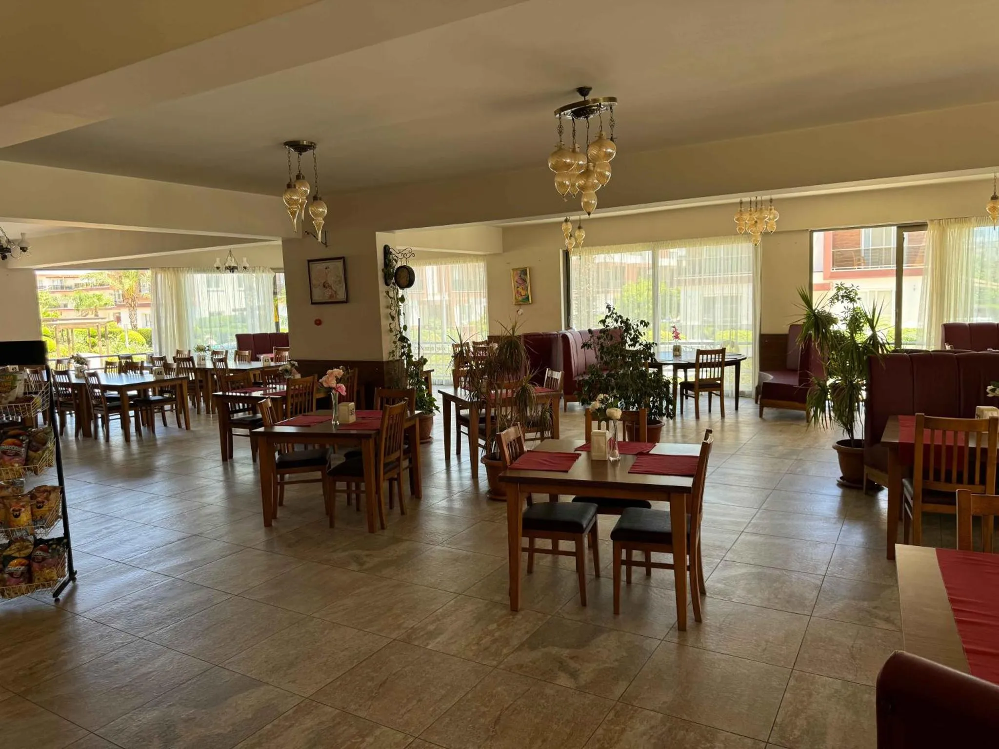 Une salle lumineuse avec des tables dressées pour le repas.