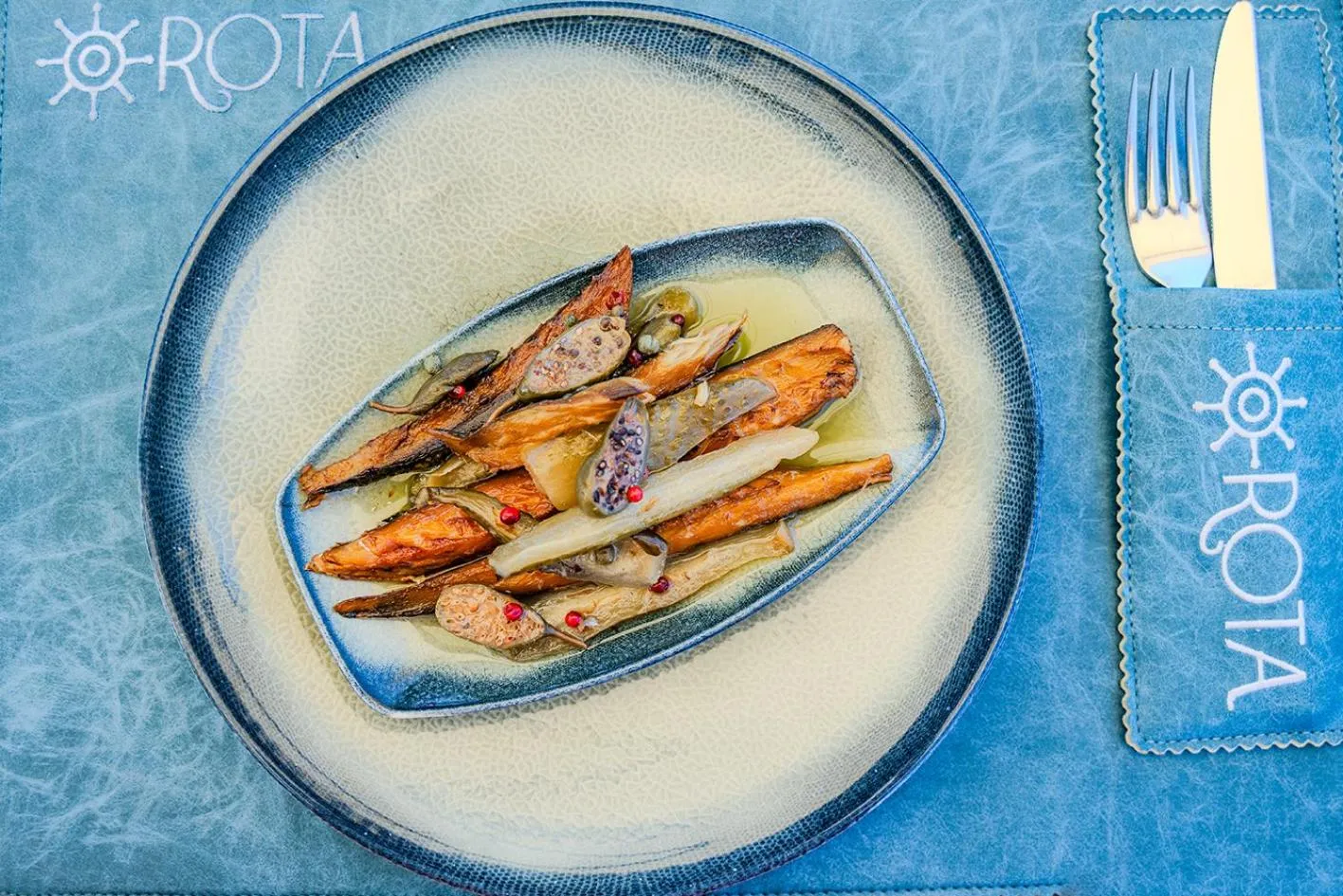 Assiette de légumes grillés et de poisson servi dans un restaurant.
