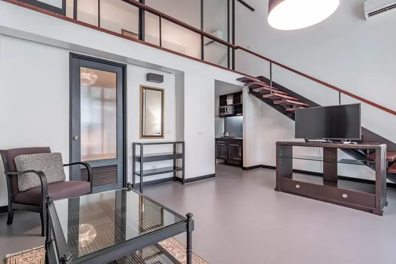 Un salon moderne avec un canapé, une table basse et un meuble télévision.